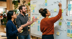 Team collaborating at a whiteboard during a feedback session